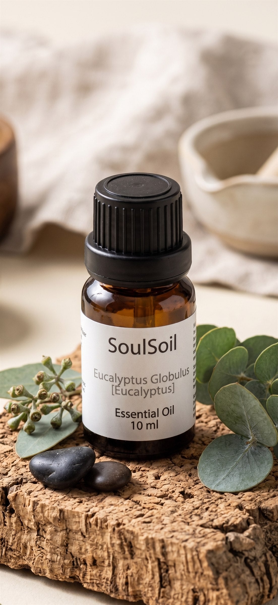 SoulSoil eucalyptus bottle, labelled Eucalyptus globulus, 10 ml, on cork bark with eucalyptus leaves, seed pods and two dark pebbles.