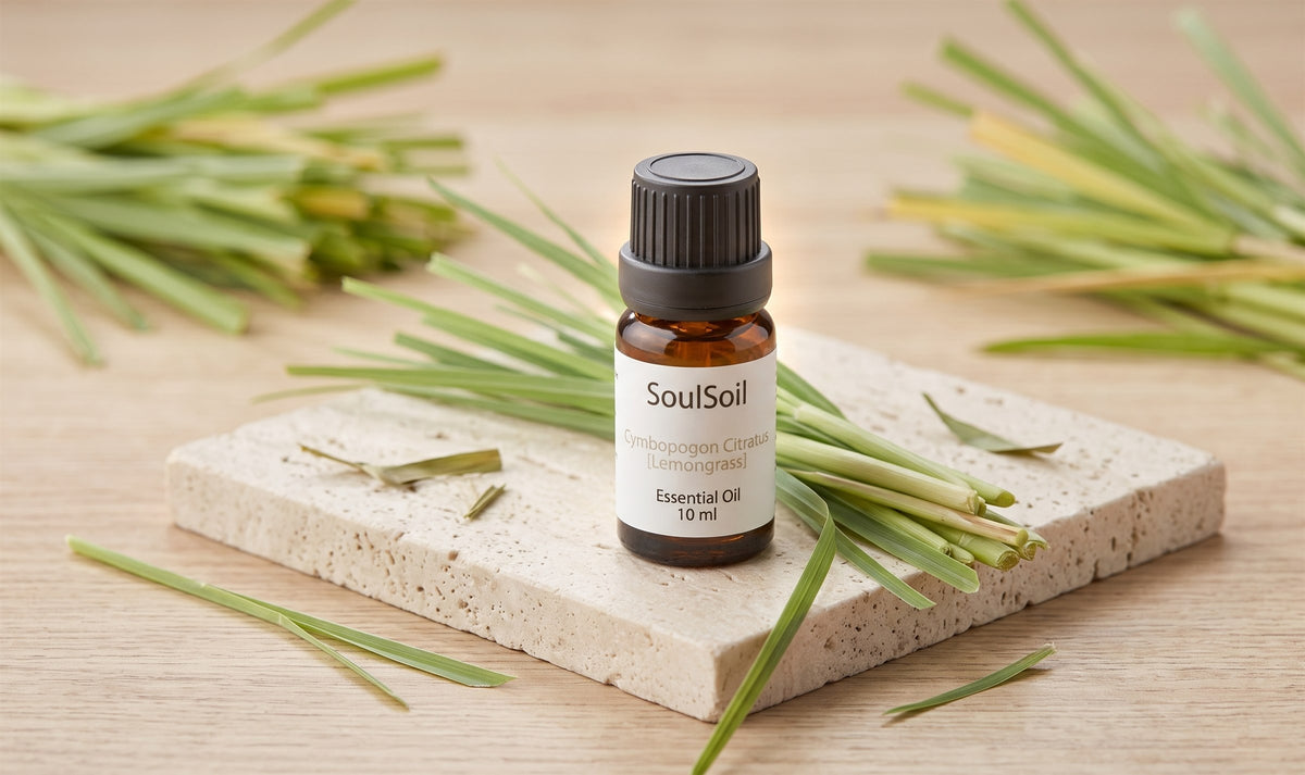 SoulSoil lemongrass bottle standing on a travertine tile on pale wood, surrounded by cut lemongrass stalks.